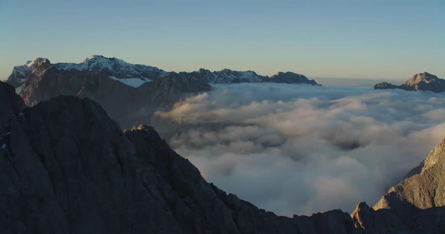 An aerial view of a mountain is displayed