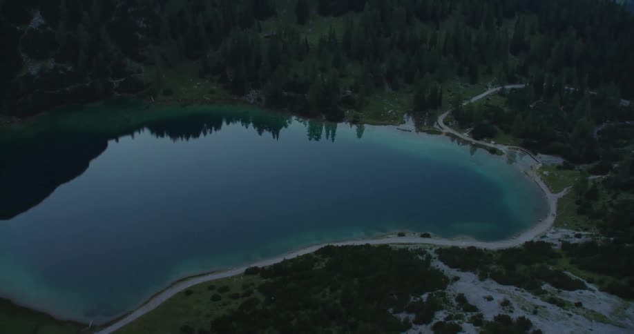 Drone shot of a small lake hidden in the forest