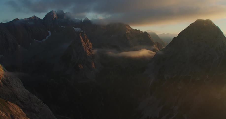 A stony mountain ridge amid the clouds on a sunny day