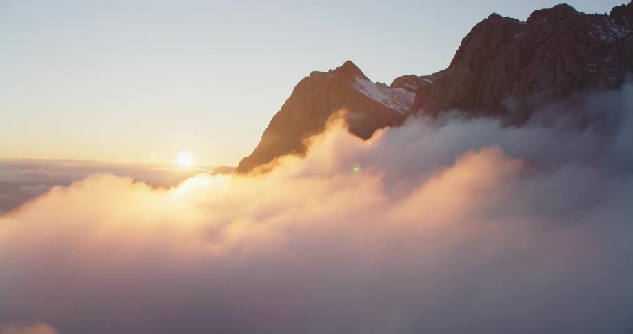 An aerial view of a mountain is displayed at dusk