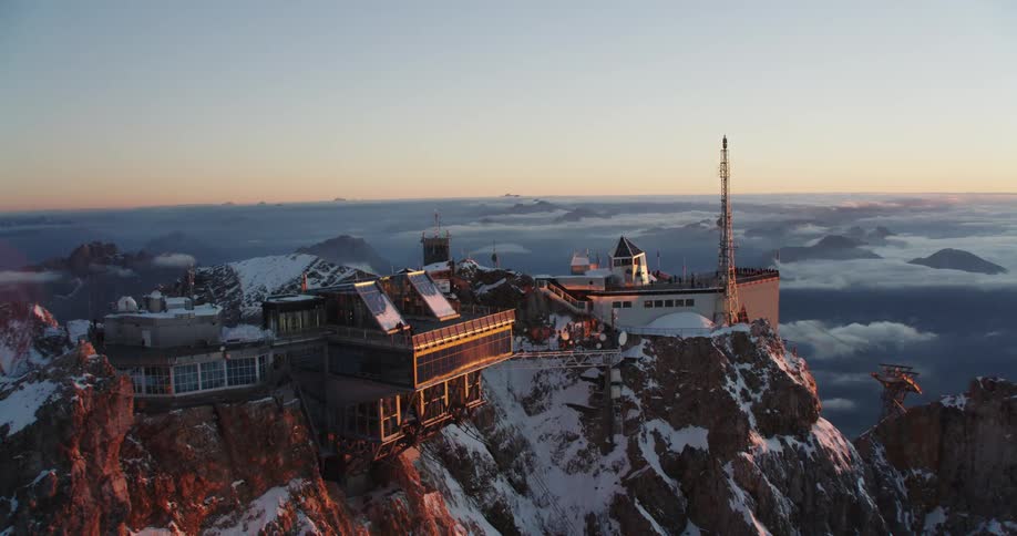 Buildings and a tower atop mountains