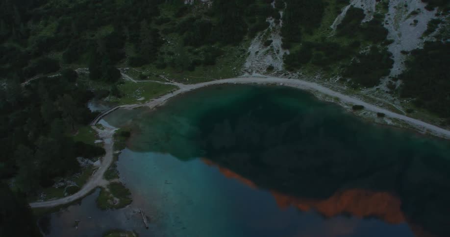 Aerial view of a small lake in the mountain at sunset