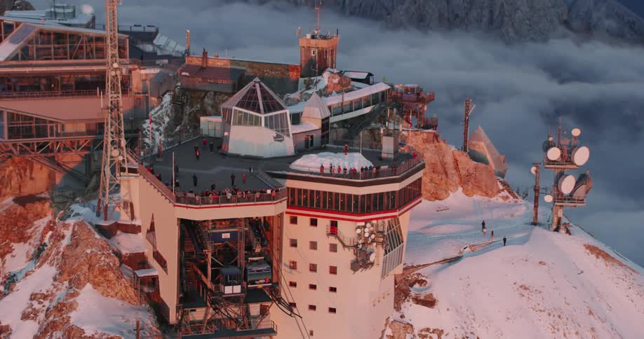 People on an observation deck in a mountain range
