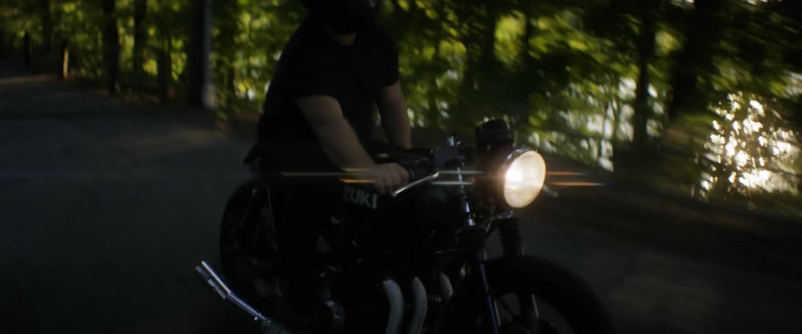 A man riding a motorcycle and standing up on it