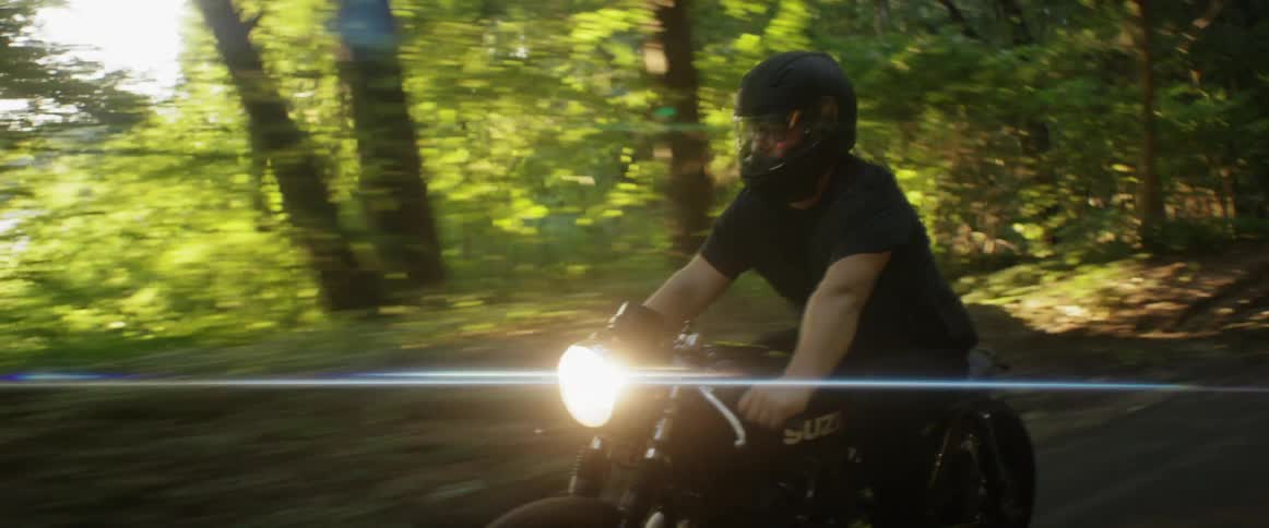 Man riding a motorcycle on a rural road