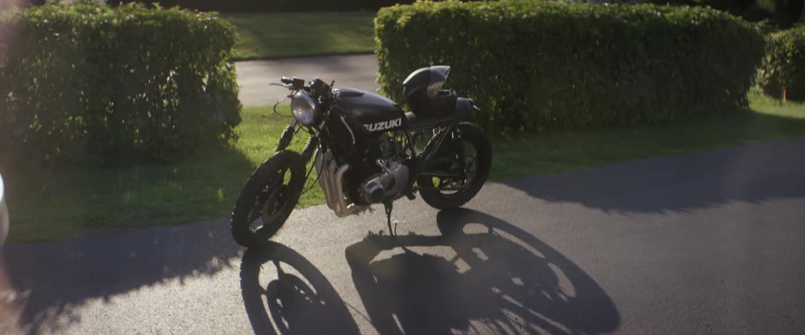 A suzuki motorcycle parked in a driveway