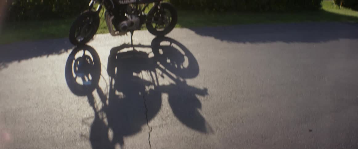 A motorcycle sits parked on the pavement
