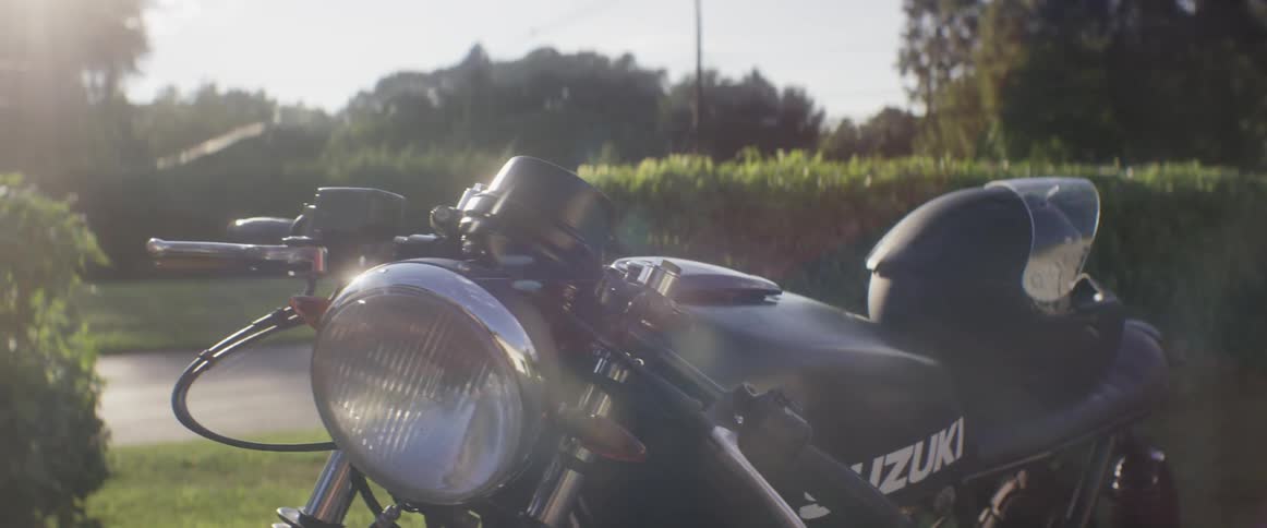 A black motorcycle is parked on a sunny day