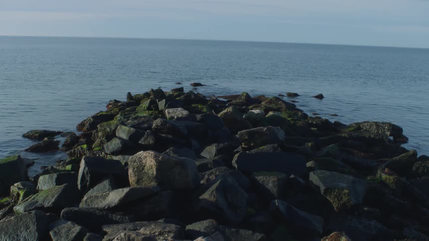 Ocean water ripples around a rocky shore
