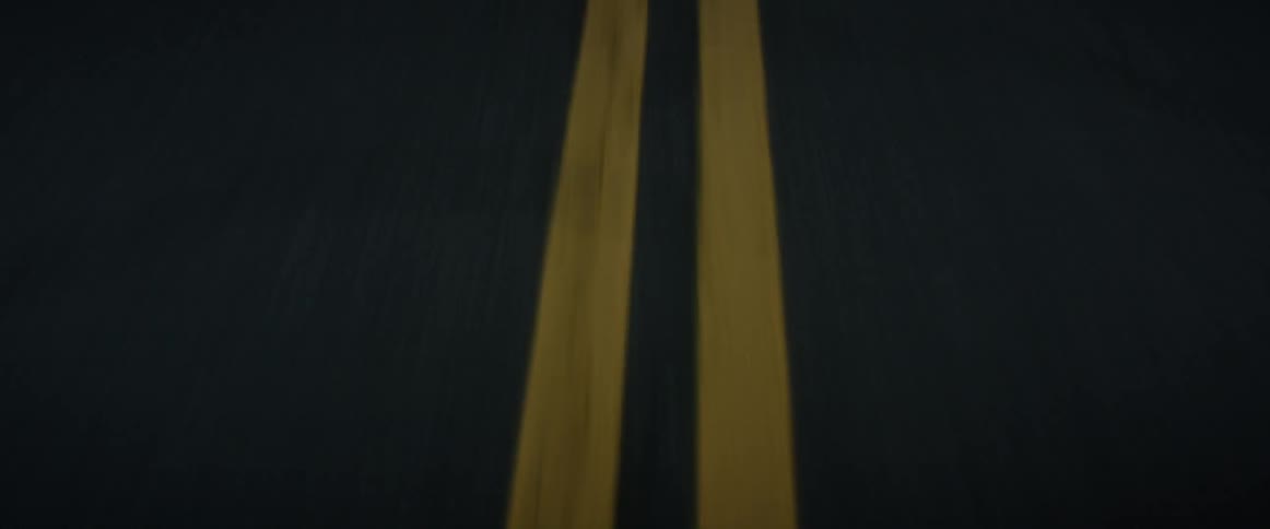 Two yellow center pavement lines on a road