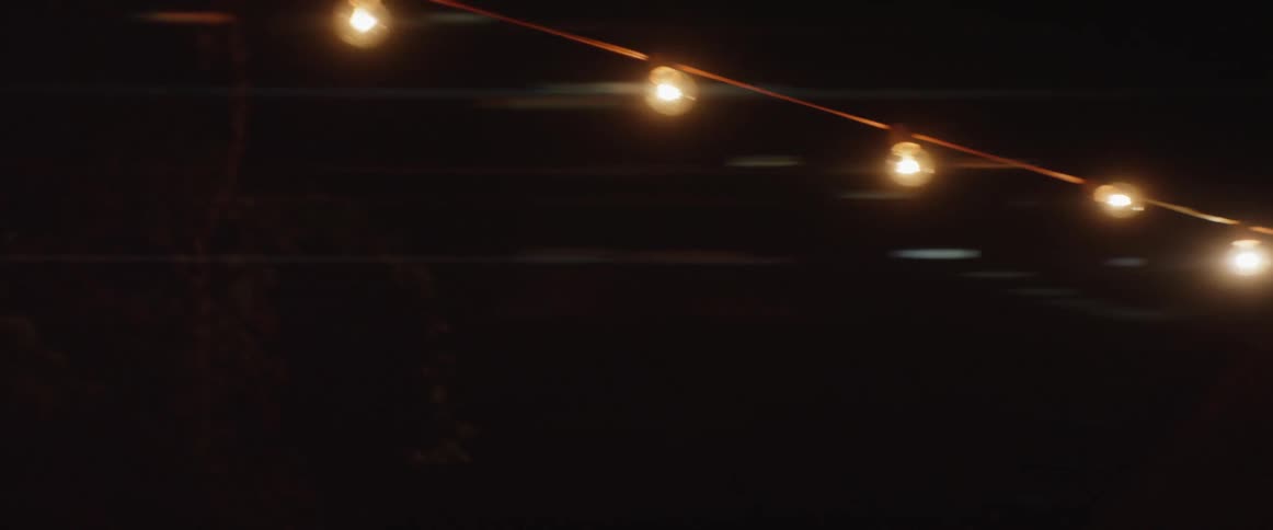 String lights shine outdoors at night