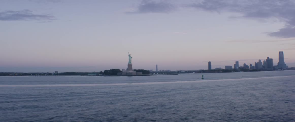 A man takes pictures of the statue of liberty
