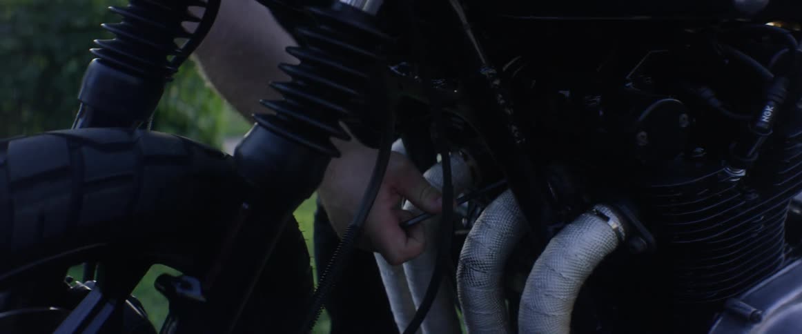 A man is trying to repair a motorcycle