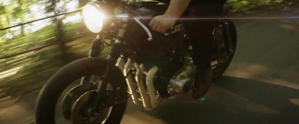 A motorcyclist rides on a rural road
