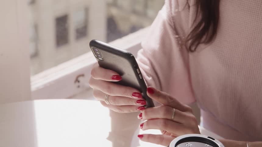 A woman is texting on a cell phone