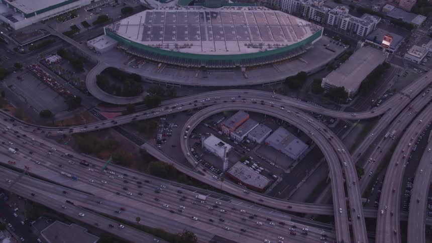 Cars are driving on highway in a downtown city
