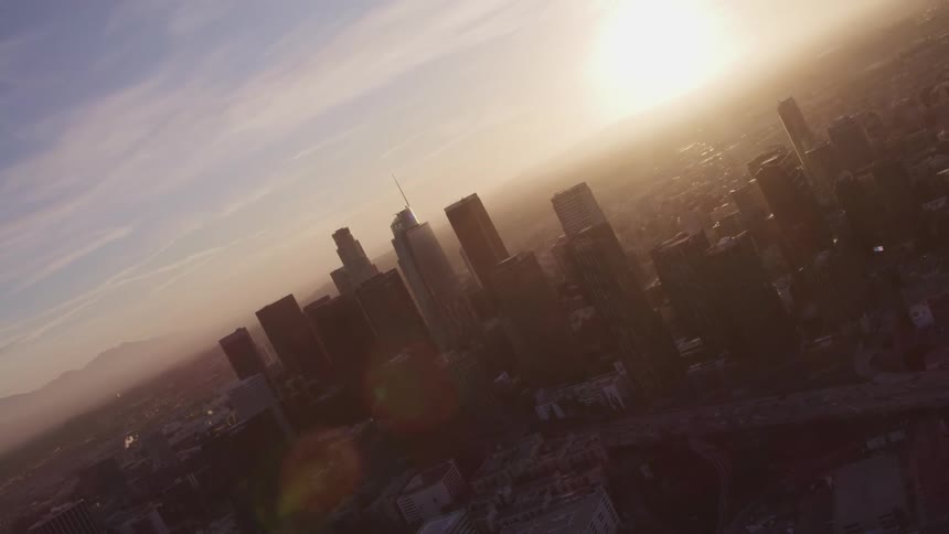 An aerial view of a cityscape at sunrise