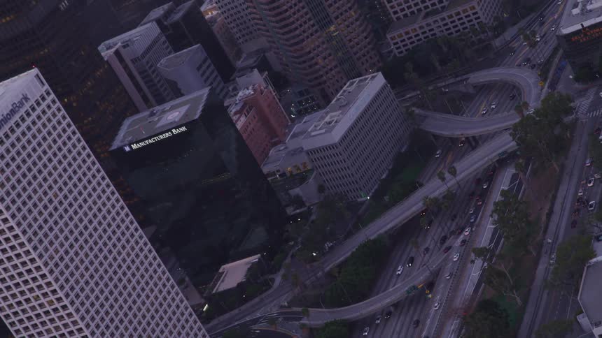Cars are driving through a downtown city
