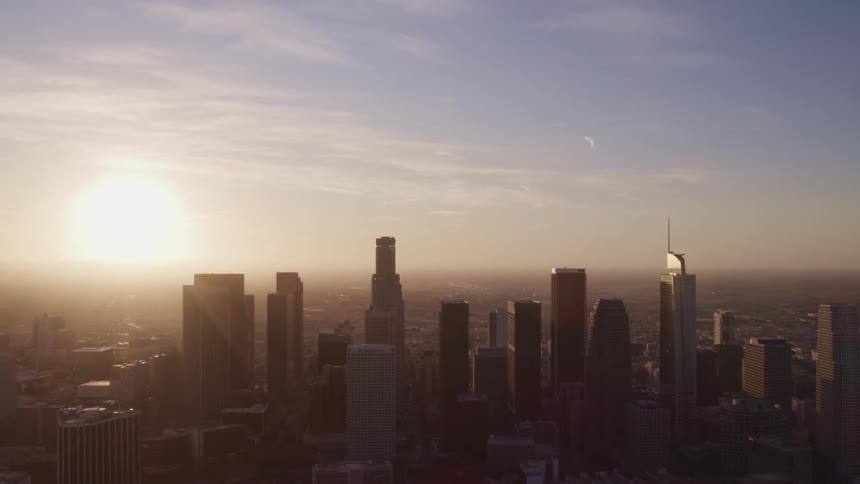 Aerial view of high rise buildings and skyscrapers at sunset