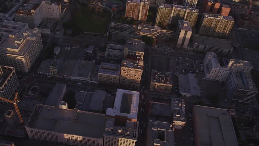 An aerial view of a city with buildings streets and cars