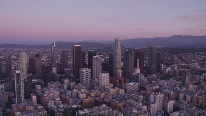 Aerial view of high rise buildings and skyscrapers at dusk