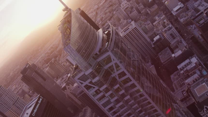An aerial view of a downtown city is displayed at dusk