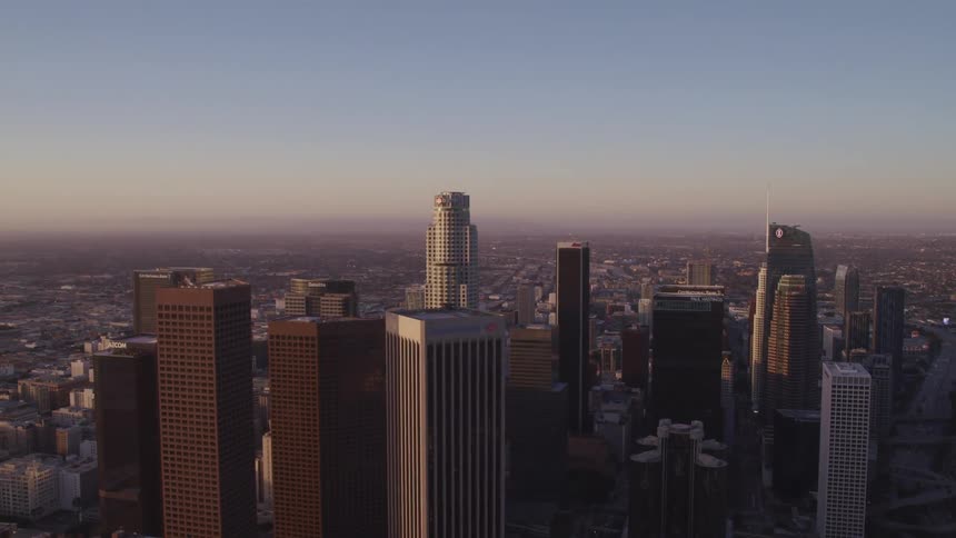 An aerial view of a downtown city skyline is displayed