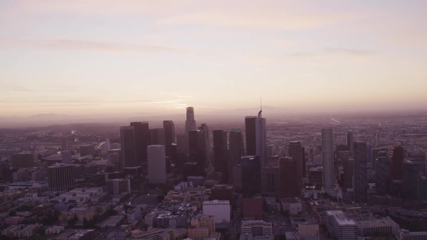 Aerial view of high rise buildings and skyscrapers at dusk