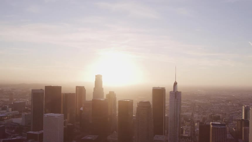 Aerial view of the silhouette of skyscrapers in the citys downtown at sunset