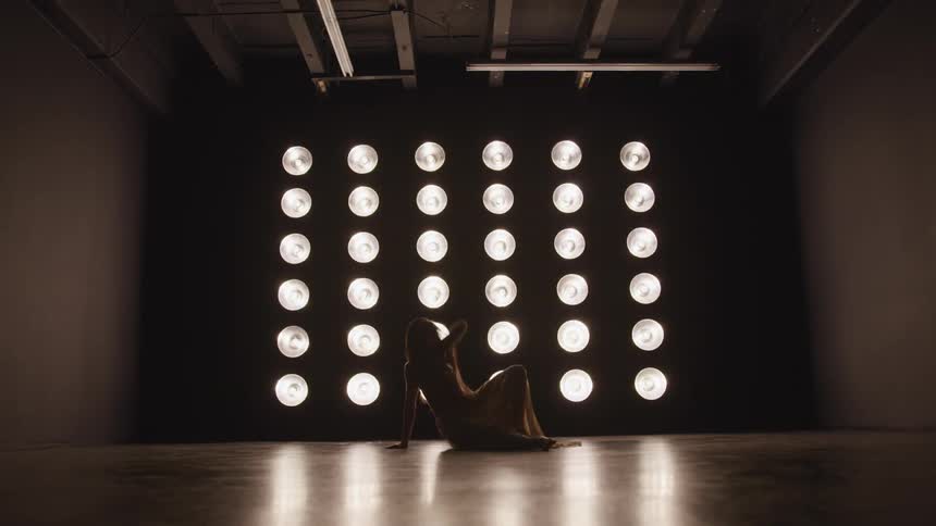 A female caucasian dancing in a studio alone