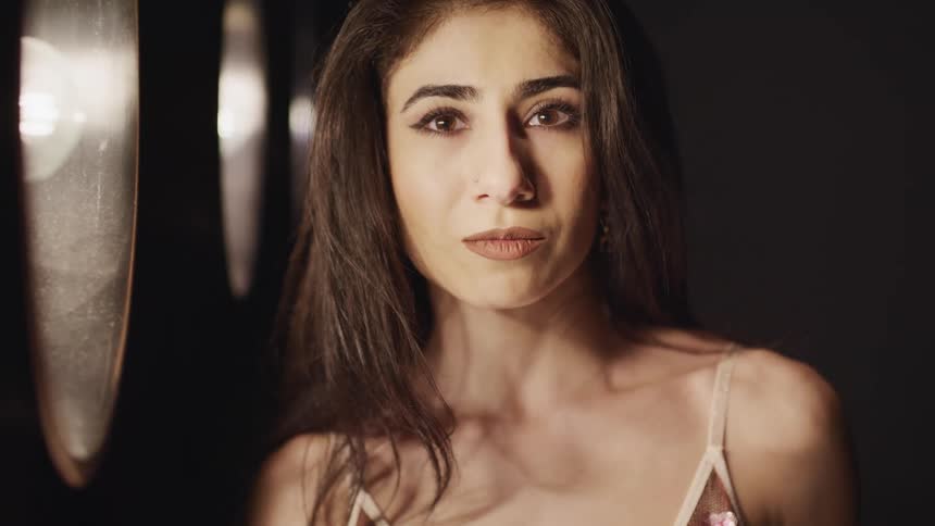 A woman standing in front of lights for a portrait