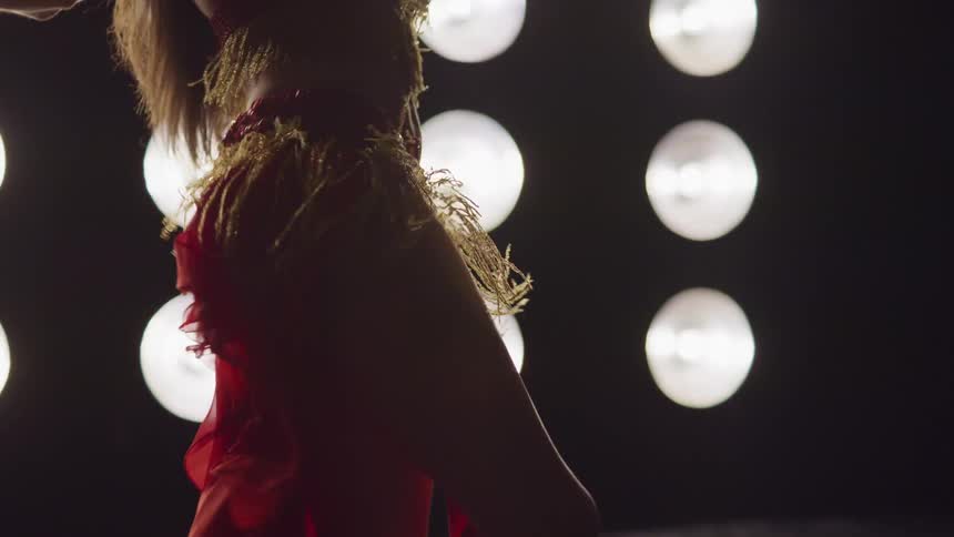 Silhouette of a female exotic dance shaking her hips on stage