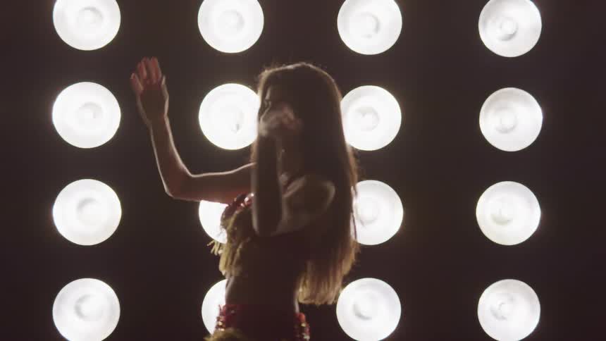 A woman is dancing in a room