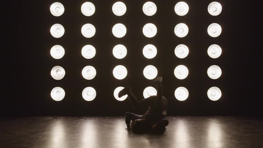 A teenage boy dancing on stage