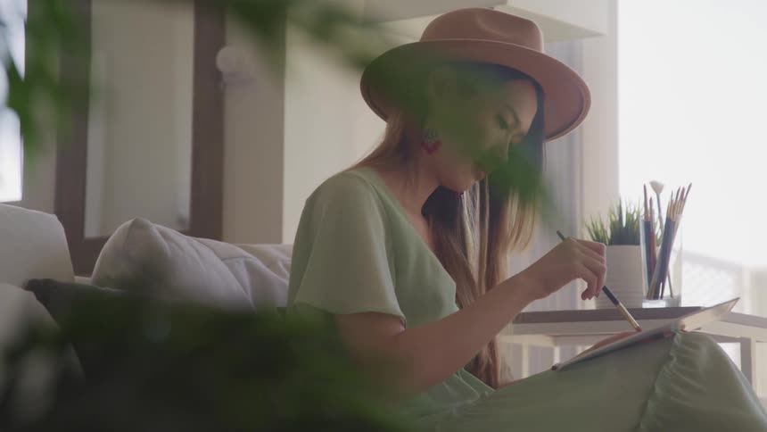 A woman is painting a picture indoors