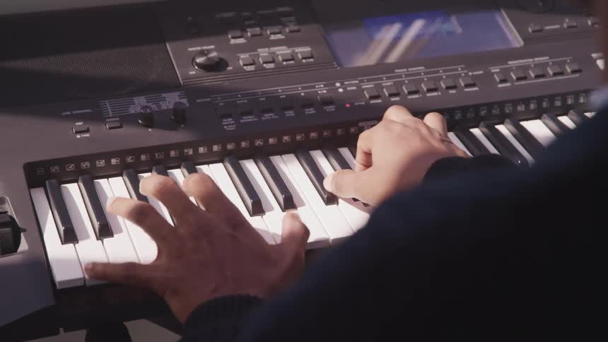 A musician plays a keyboard