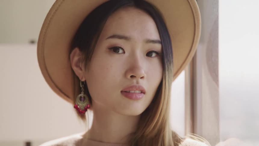 A woman is wearing a hat indoors