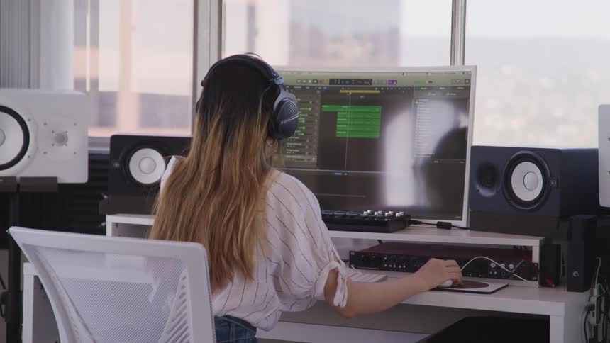 A woman is working on a computer indoors