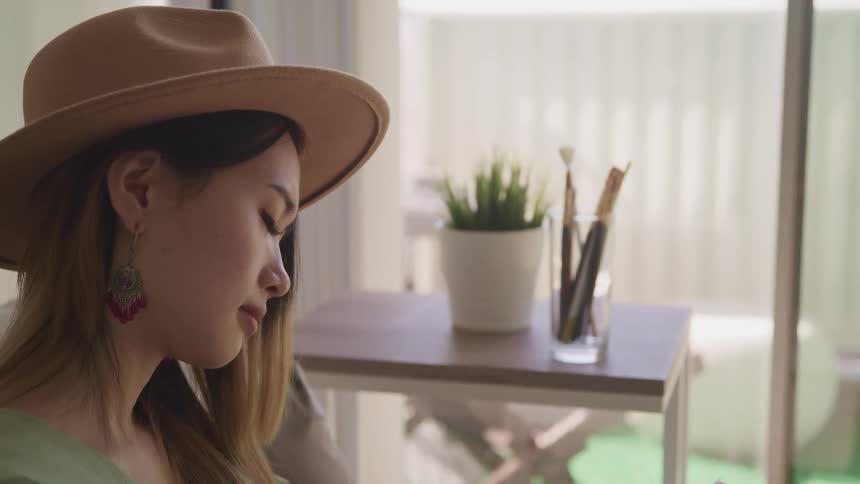 A teenage girl sitting at home reading
