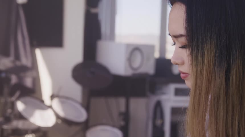 A woman is working in a sound studio