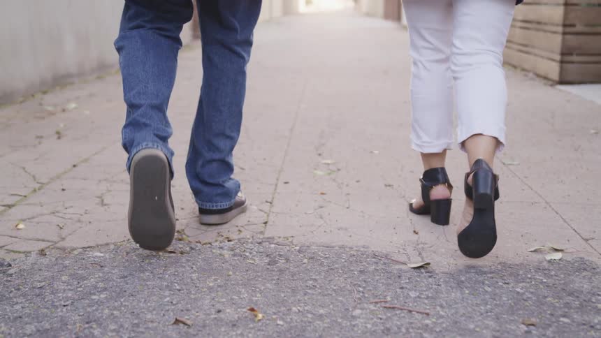 Two people are walking outdoors together
