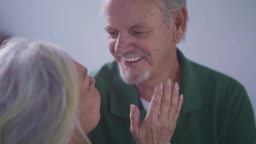 A woman touches a mans face