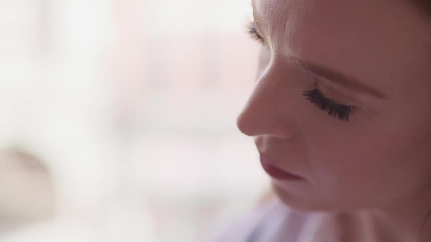 Side view of a woman with makeup looking into space