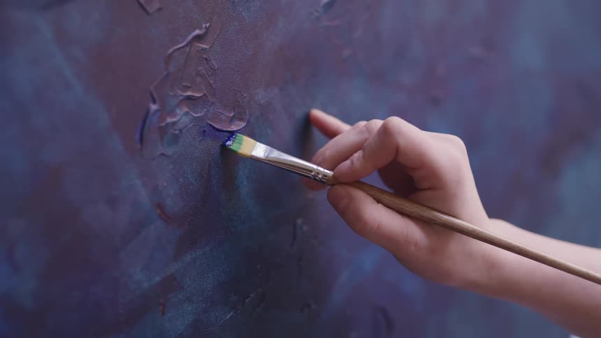 A woman painting on a canvas