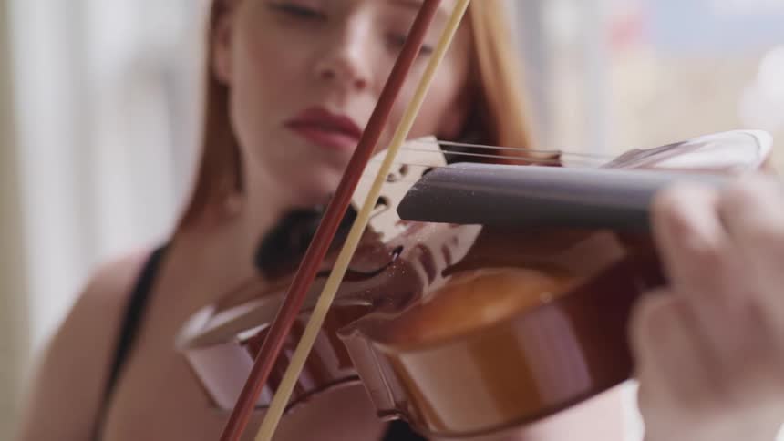 A woman is playing the violin