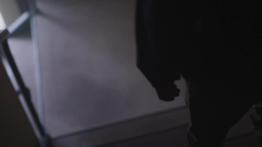 Man going down the stairs is silhouetted