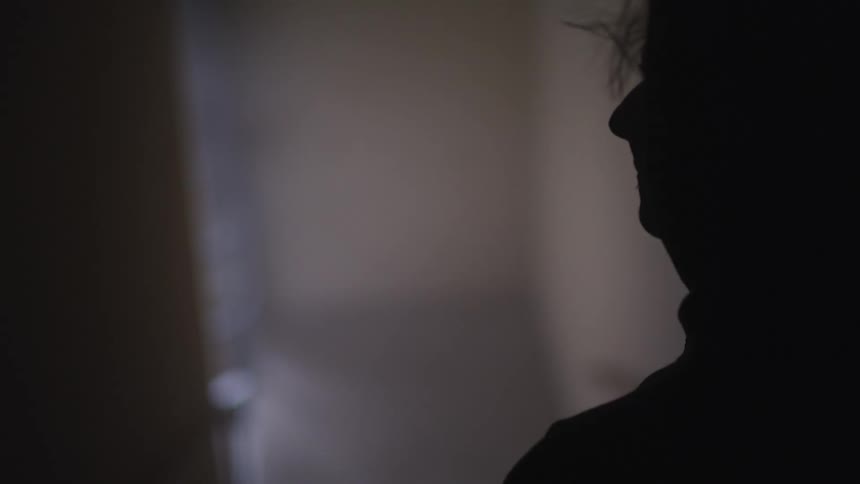 Side view of a man in silhouette standing on the stairs