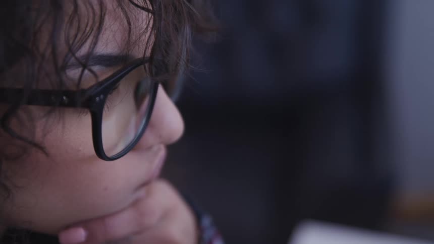Woman props chin on hand as she contemplates then smiles