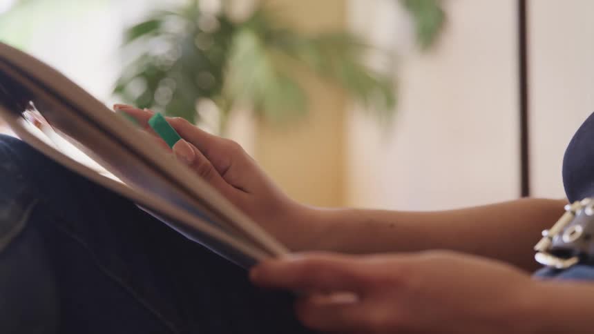 A woman sitting at home using her tablet
