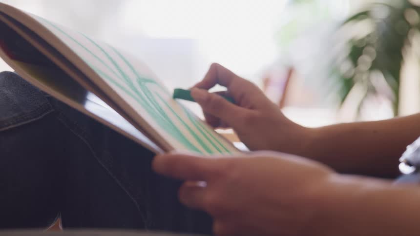 A person is drawing on a pad with chalk